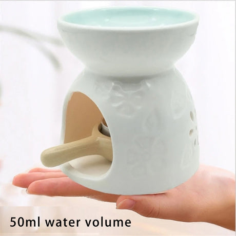 White ceramic oil burner held in a hand with '50ml water volume' text.