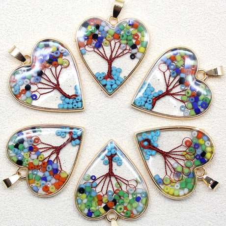 Set of heart-shaped beaded pendants on a white background