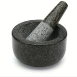 Black stone mortar and pestle on a white background