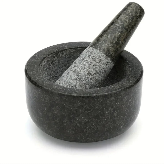 Black stone mortar and pestle on a white background