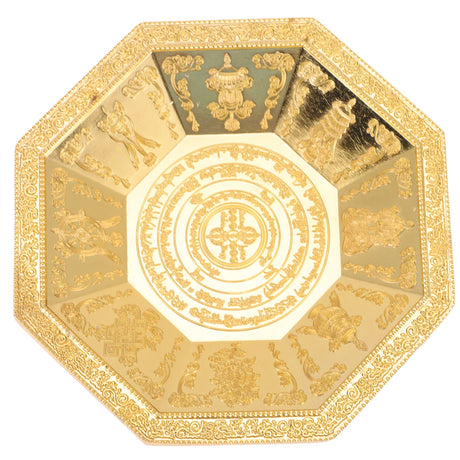 Decorative gold plate with intricate designs on a white background