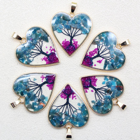 Set of heart-shaped pendants with tree design on a white background