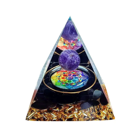 Triangular pyramid with colorful crystal ball and decorative elements on a white background