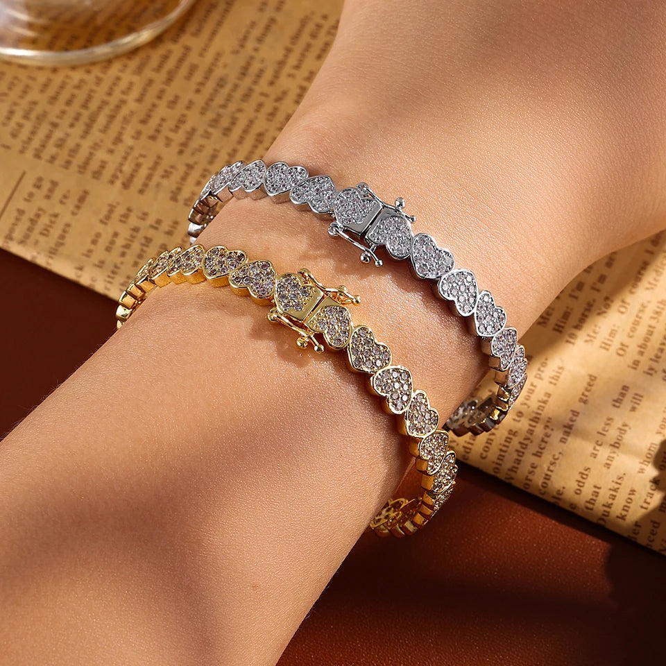 Two diamond-encrusted bracelets on a wrist with a vintage book background