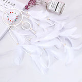 Decorative setup with fairy lights, a small bottle, and decorative items on a white surface.