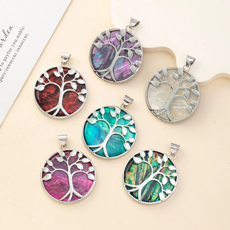 Set of colorful tree-shaped pendants on a beige surface