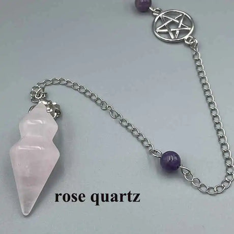 Rose quartz crystal and amethyst bead on a silver chain against a light gray background