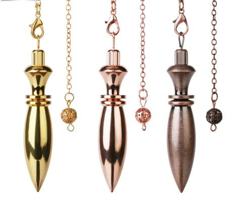Three metallic pendulums in gold, rose gold, and bronze on white background