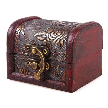 Decorative wooden box with metal lock and intricate designs on a white background