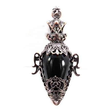 Decorative pendant with black stone and intricate metalwork on a white background