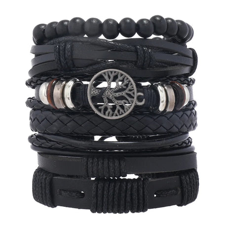 Stack of black leather and beaded bracelets with a central tree-of-life charm on a white background