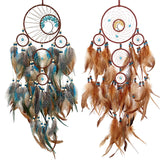 Two dreamcatchers with feathers on a white background