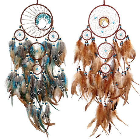 Two dreamcatchers with feathers on a white background