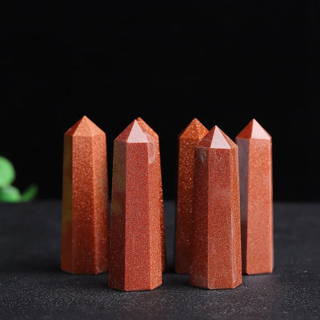 Five red crystal points on a dark background