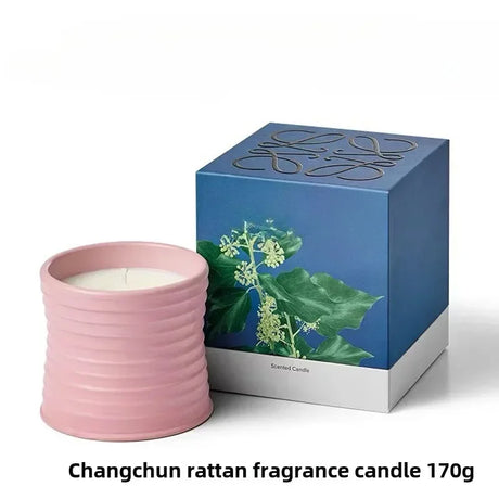 Pink rattan fragrance candle with a blue box featuring floral design on a white background