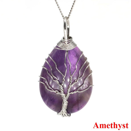 Purple amethyst pendant with silver tree design on a white background