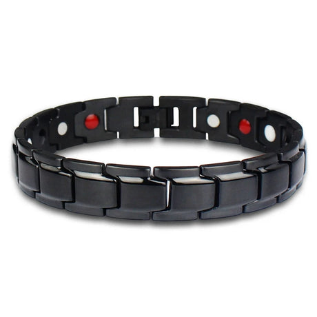 Black metal bracelet with red and white beads on a white background