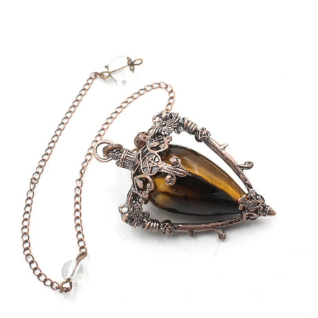 Necklace with a large brown gemstone and intricate metalwork on a white background