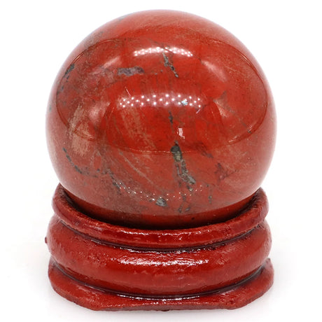 Red stone sphere on a matching red stand against a white background