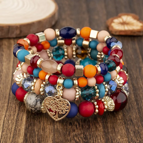 Colorful beaded bracelet with a heart charm on a wooden surface
