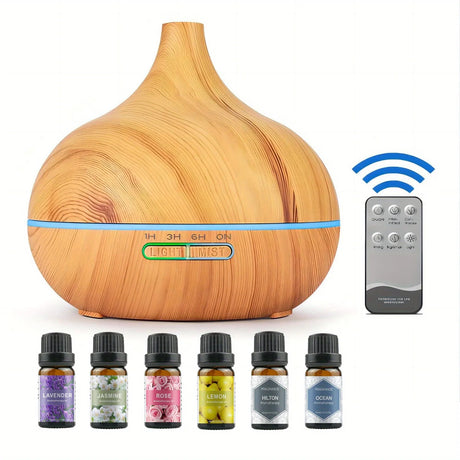 Wooden diffuser with remote control and essential oil bottles on a white background