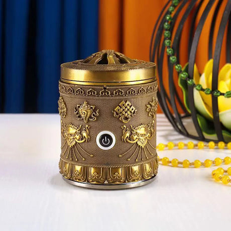 Decorative brass incense burner with intricate designs on a white surface.