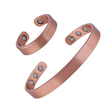 Two copper bracelets with magnetic stones on a white background