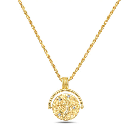 Gold necklace with a circular pendant on a white background