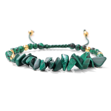 Green beaded bracelet with gold accents on a white background