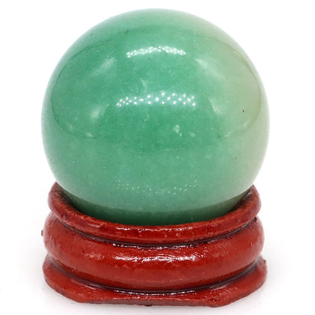 Green jade sphere on a red stand against a white background