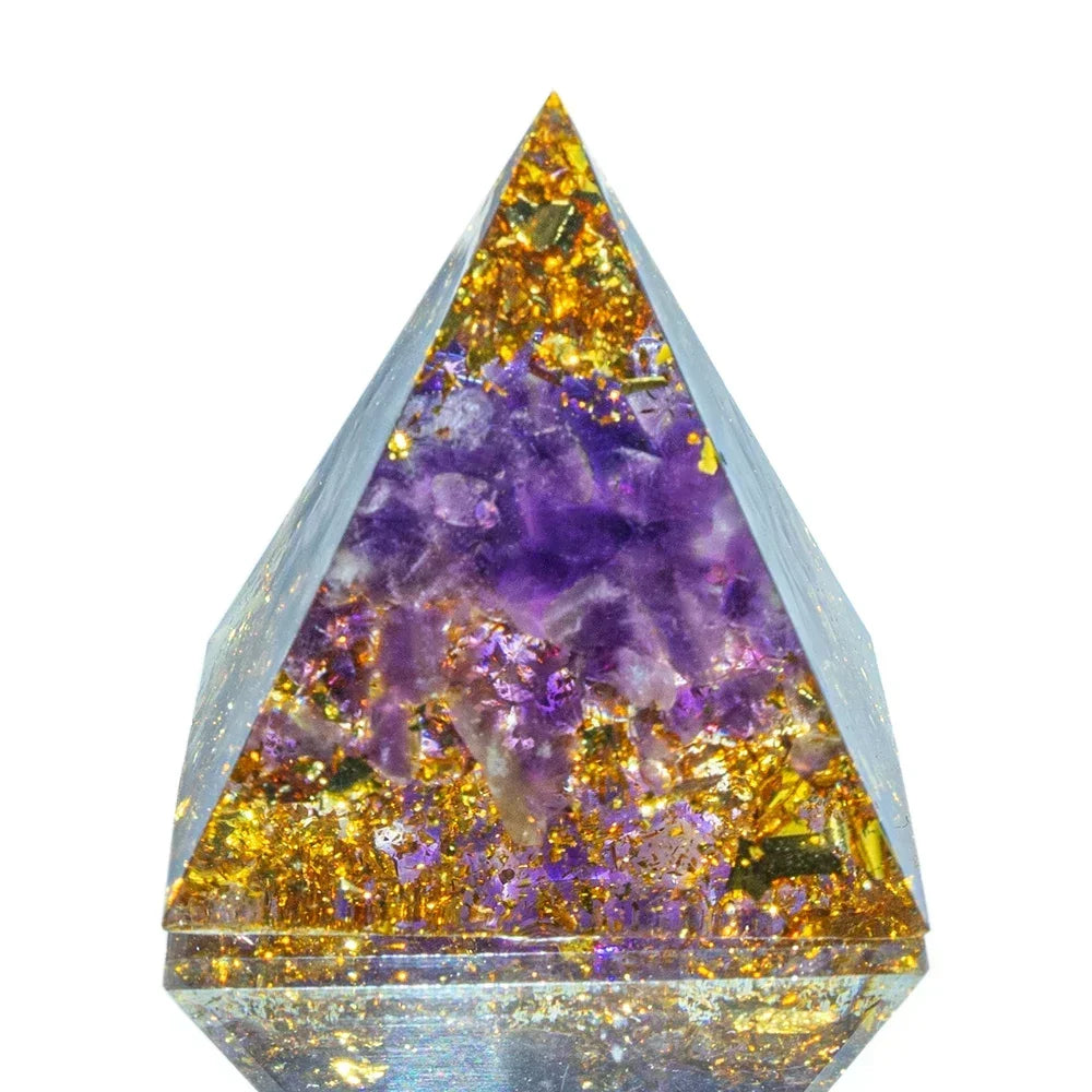 Crystal pyramid with purple and gold interior on a white background