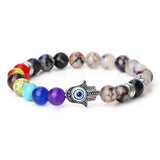 Beaded bracelet with a Hamsa hand charm on a white background