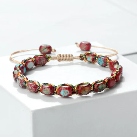 Beaded bracelet with red and multicolored beads on a white surface