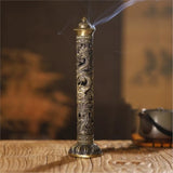 Decorative incense stick with dragon design on a wooden surface