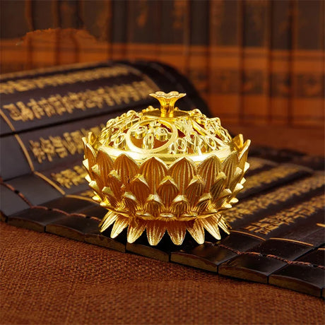 Gold lotus-shaped decorative item on a textured surface