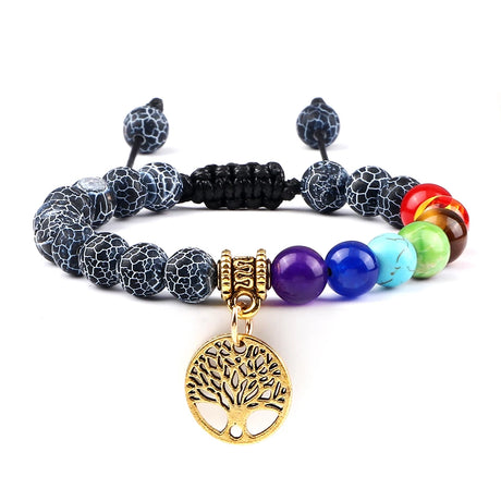 Multicolored beaded bracelet with a gold tree of life charm on a white background
