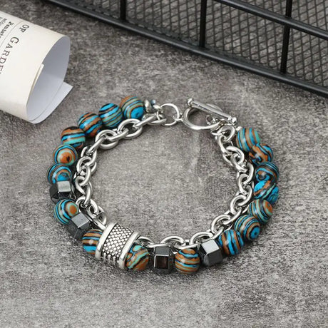 Bracelet with blue and brown beads on a gray surface