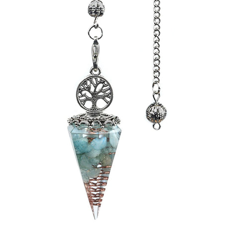 Crystal pendulum with silver tree of life design on a white background