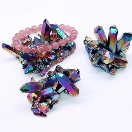 Colorful crystal-like objects with pink beads on a white background