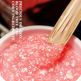 Pink gel with a gold applicator and text about precious dragon blood tree and corn ingredients.