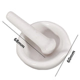 White ceramic mortar and pestle with measurements on a white background