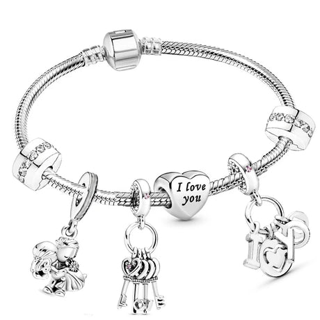 Silver bracelet with various charms on a white background