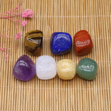 Set of colorful crystals on a woven mat with pink flowers.