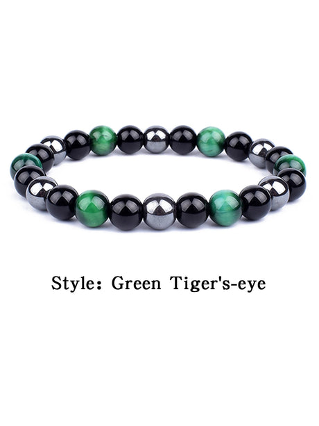 Black and green beaded bracelet on a white background