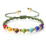 Colorful beaded bracelet with green cord on a white background