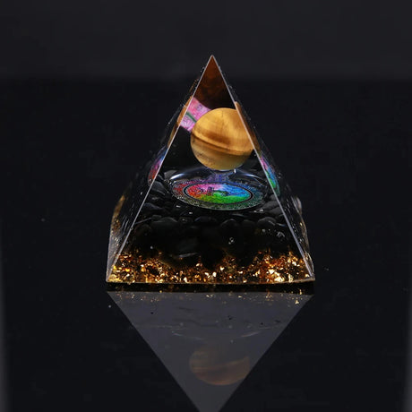 Pyramid-shaped object with a reflective surface displaying a colorful inner scene on a black background