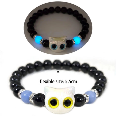 Black beaded bracelet with owl-shaped beads on a white background