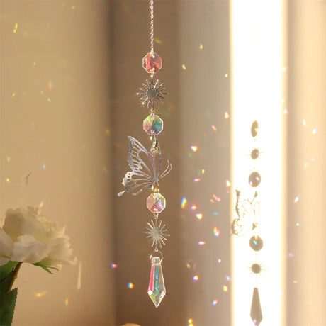Decorative hanging crystal with butterfly design in front of a light curtain