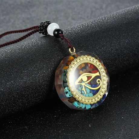 Pendant with eye design on a dark surface