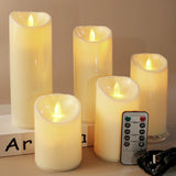 Set of five flameless candles with a remote control on a neutral background